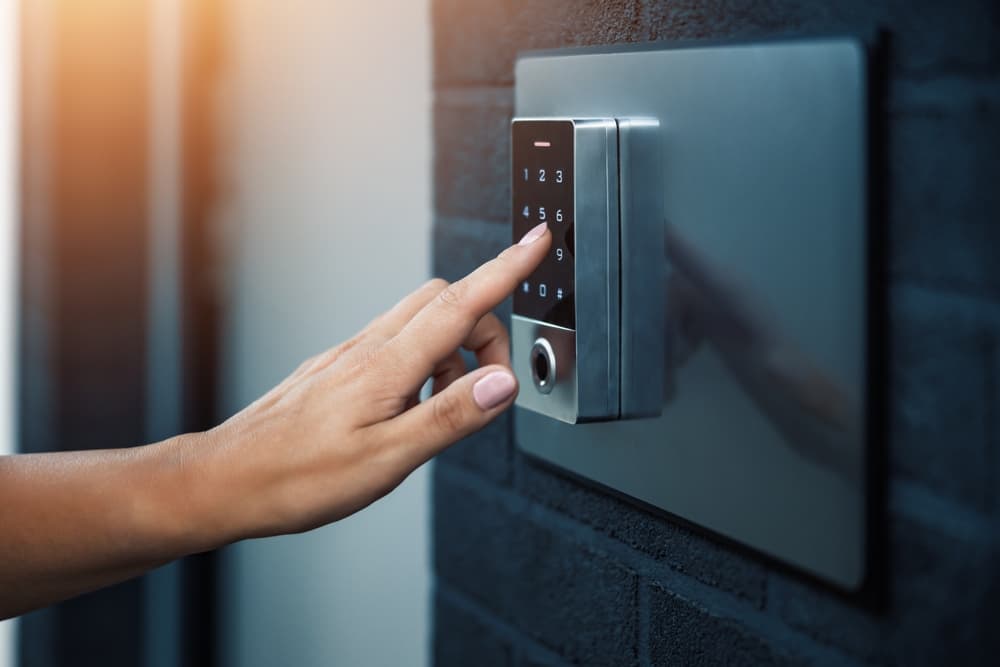 close-woman-using-intercom-building-entrance